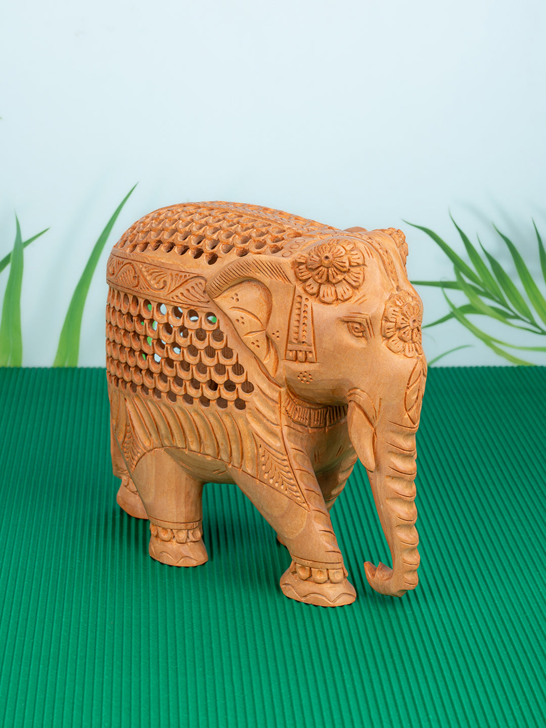 Kadam wood intricately carved elephant, trunk down - 7 inches